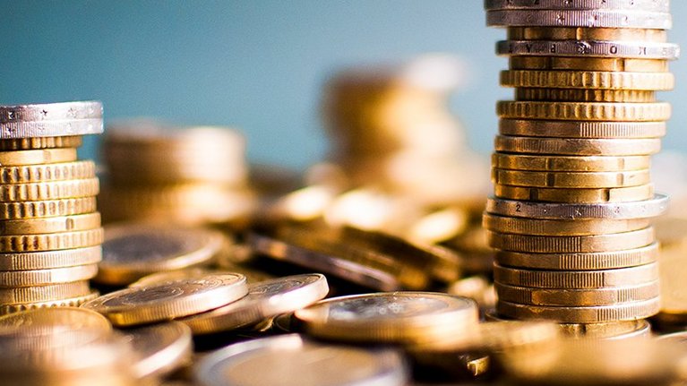 Two towers of euro money coins on a pile of other coins