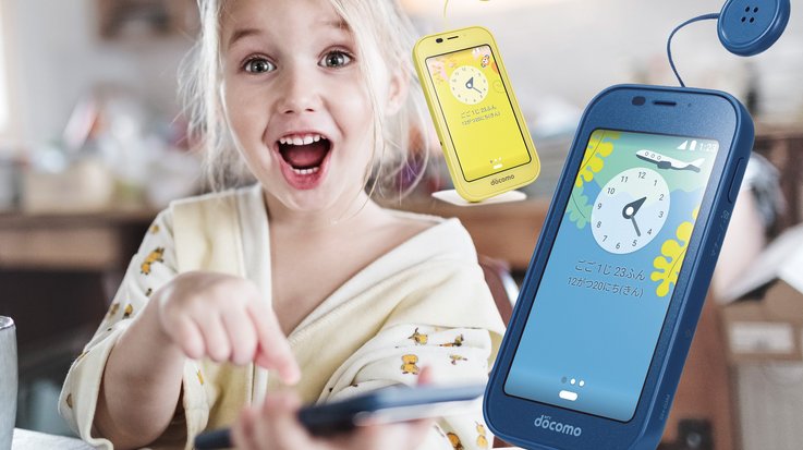 Smiling girl who is excited using a kids’ mobile phone