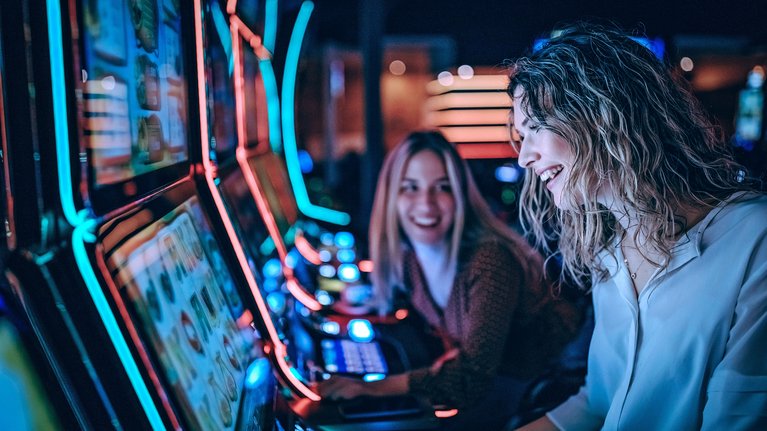 Two women at the slot machine