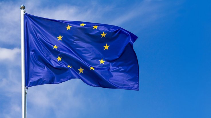 Waving European flag against blue sky