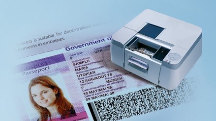 3D model of a printer standing on a highly magnified identity document