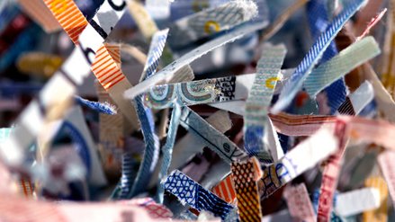 Close up of small snippets of shredded euro banknotes