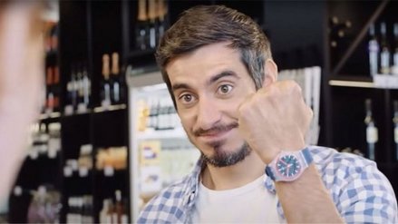 A man proudly holds up his smartwatch on his wrist to show it off