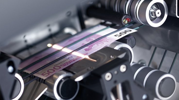 View into the interior of a machine in which a banknote is being x-rayed