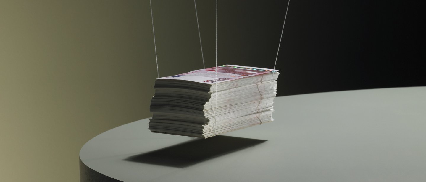 Pile of 10-euro notes hanging on string