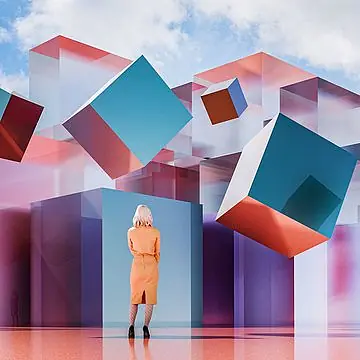 A woman in an orange dress gazes at floating, colorful geometric cubes.