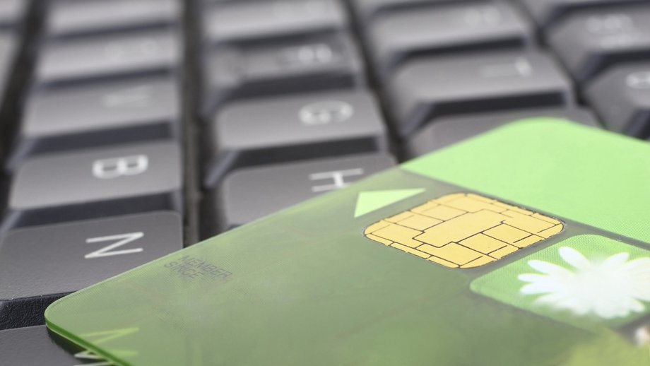 Green payment card in front of a keyboard