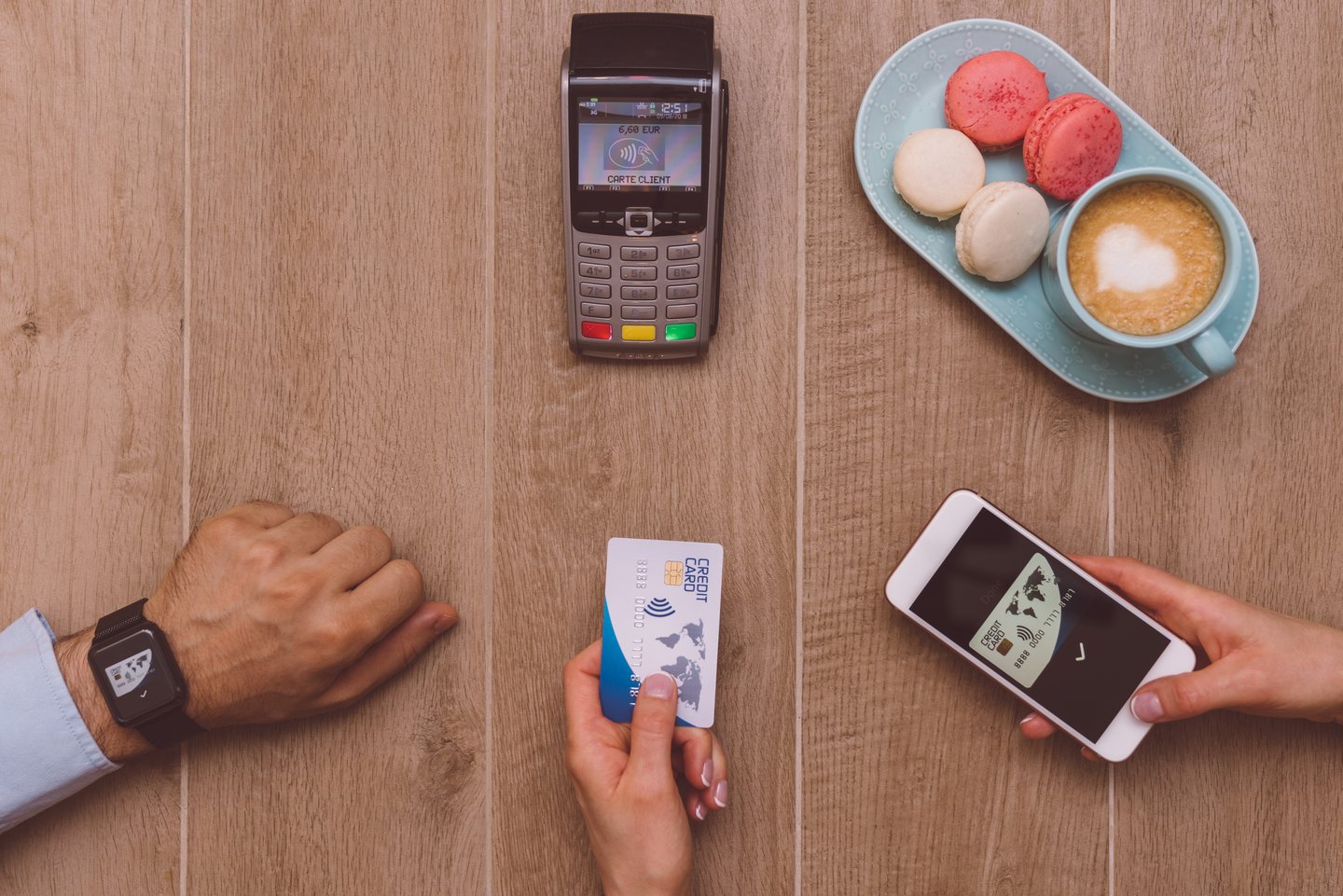 Digital wallet, mobile payment and credit card ready to pay for coffee and macaroons at POS terminal
