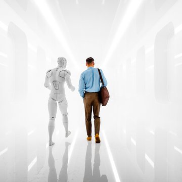 A man in business attire walks alongside a humanoid robot down a brightly lit, futuristic corridor.