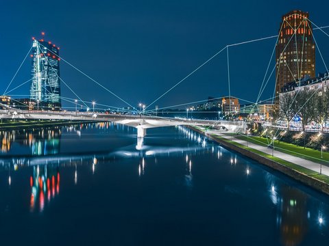 Blockchain network spanning across the Frankfurt city skyline and the European Central Bank at night