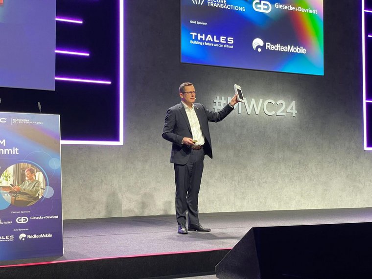 male person showing a device on stage of the MWC24 summit in Barcelona