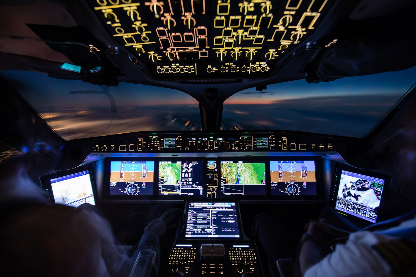 Plane cockpit with clouds and sunrise in background