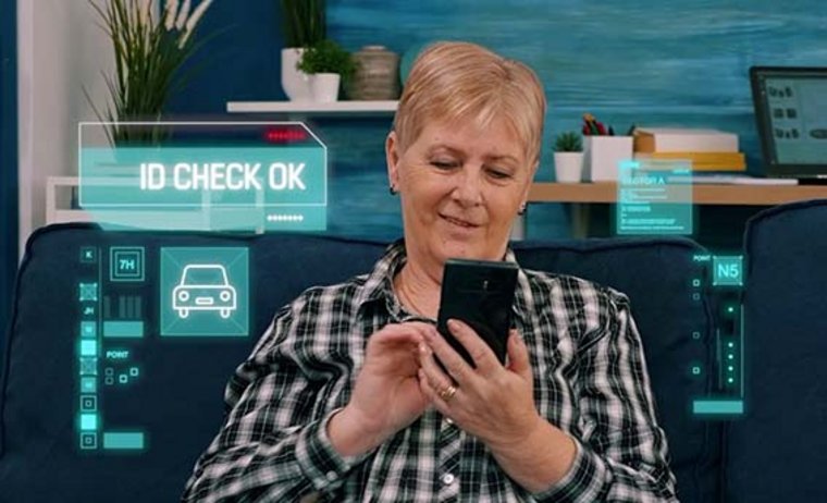 A woman operates her smartphone and has her identity checked
