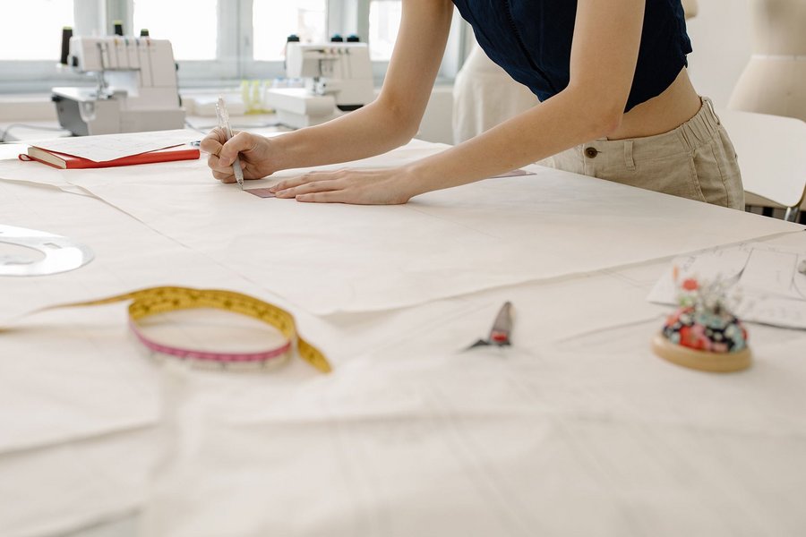 A woman working at a dressmaking table