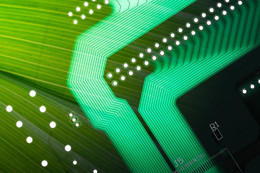 Environmental protection concept representing sustainable payment cards, Circuit board with green leaf, close-up view