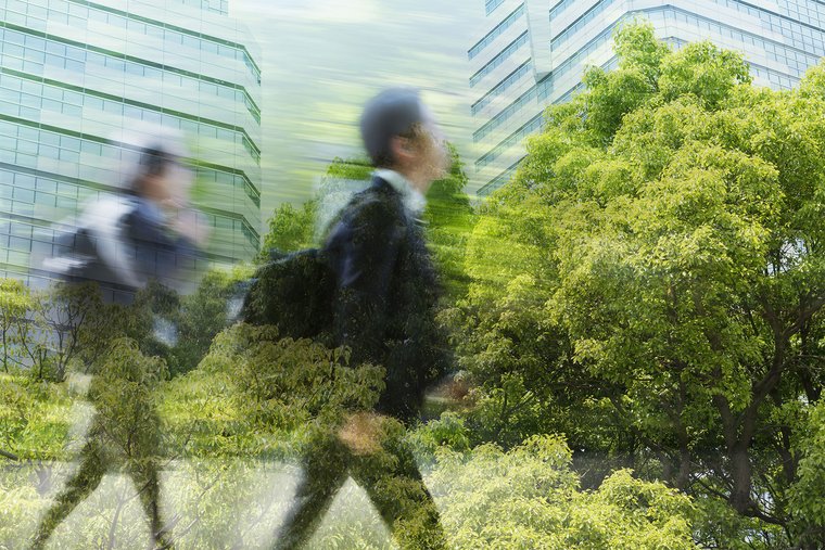 Business people walking through green office district