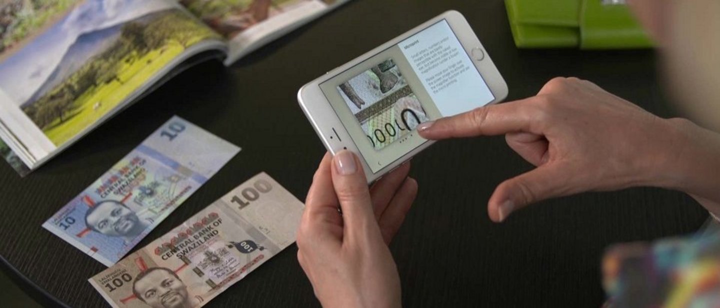 Development of currency, looking back at the currency union in Germany and Europe on a mobile.