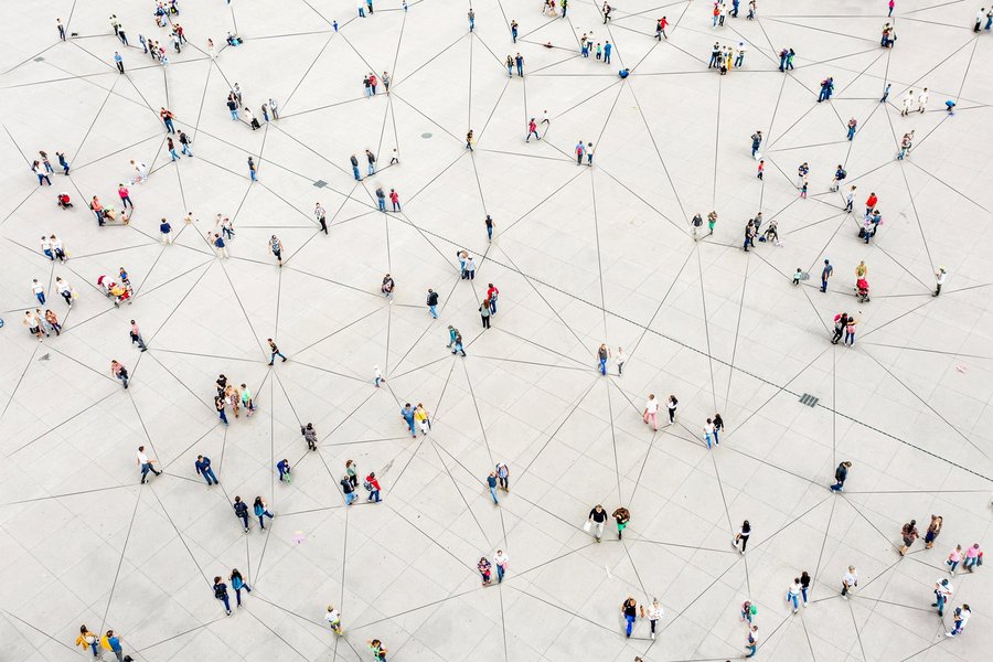 Aerial view of crowd connected by lines symbolizing digital future.