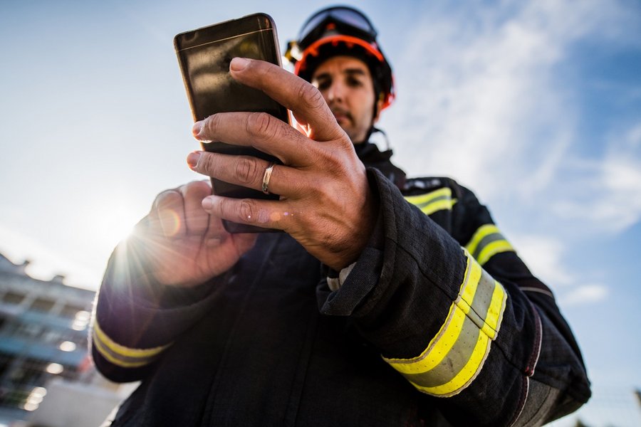 Firefighter on duty with mobile phone