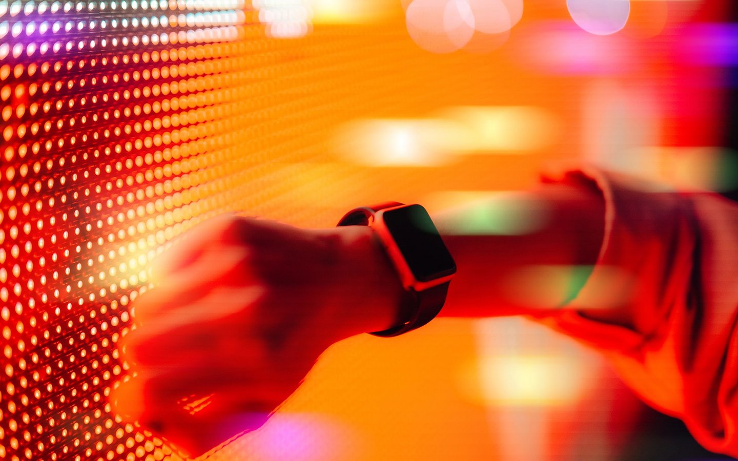Women holds her smartwatch against a digital wall