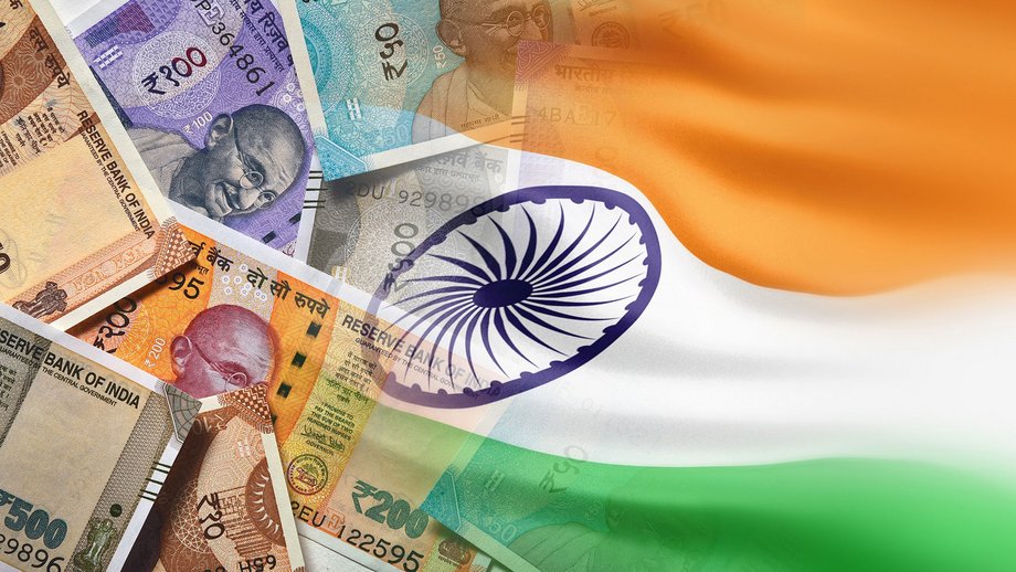 Indian cash next to an Indian flag